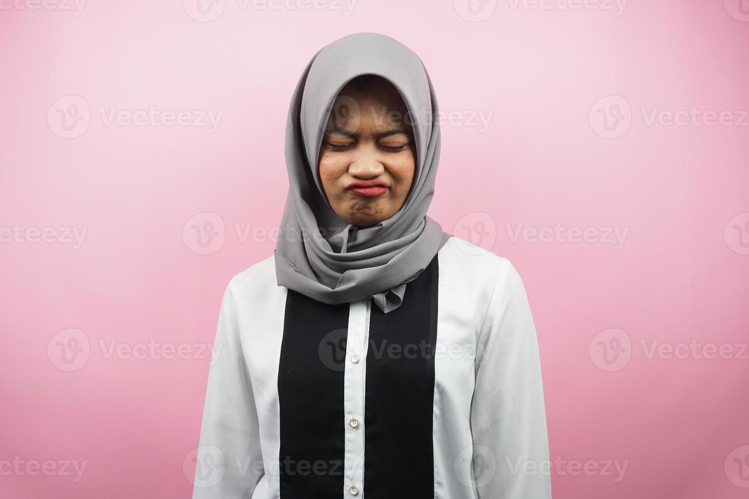 Beautiful asian young muslim woman pouting, disappointed, unhappy, dissatisfied, isolated on pink background photo