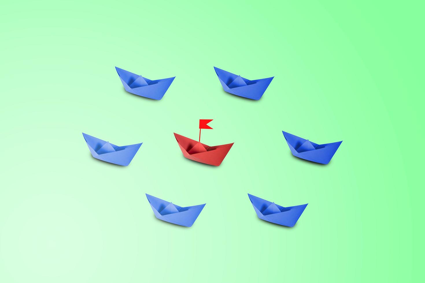 Red paper ship leading in pastel background photo