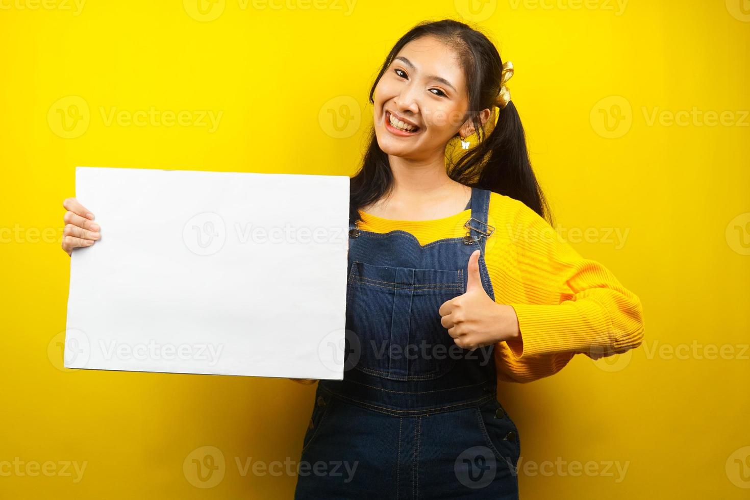 Pretty and cute young woman cheerful holding blank empty banner, placard, white board, blank sign board, white advertisement board, presenting something in copy space, promotion photo