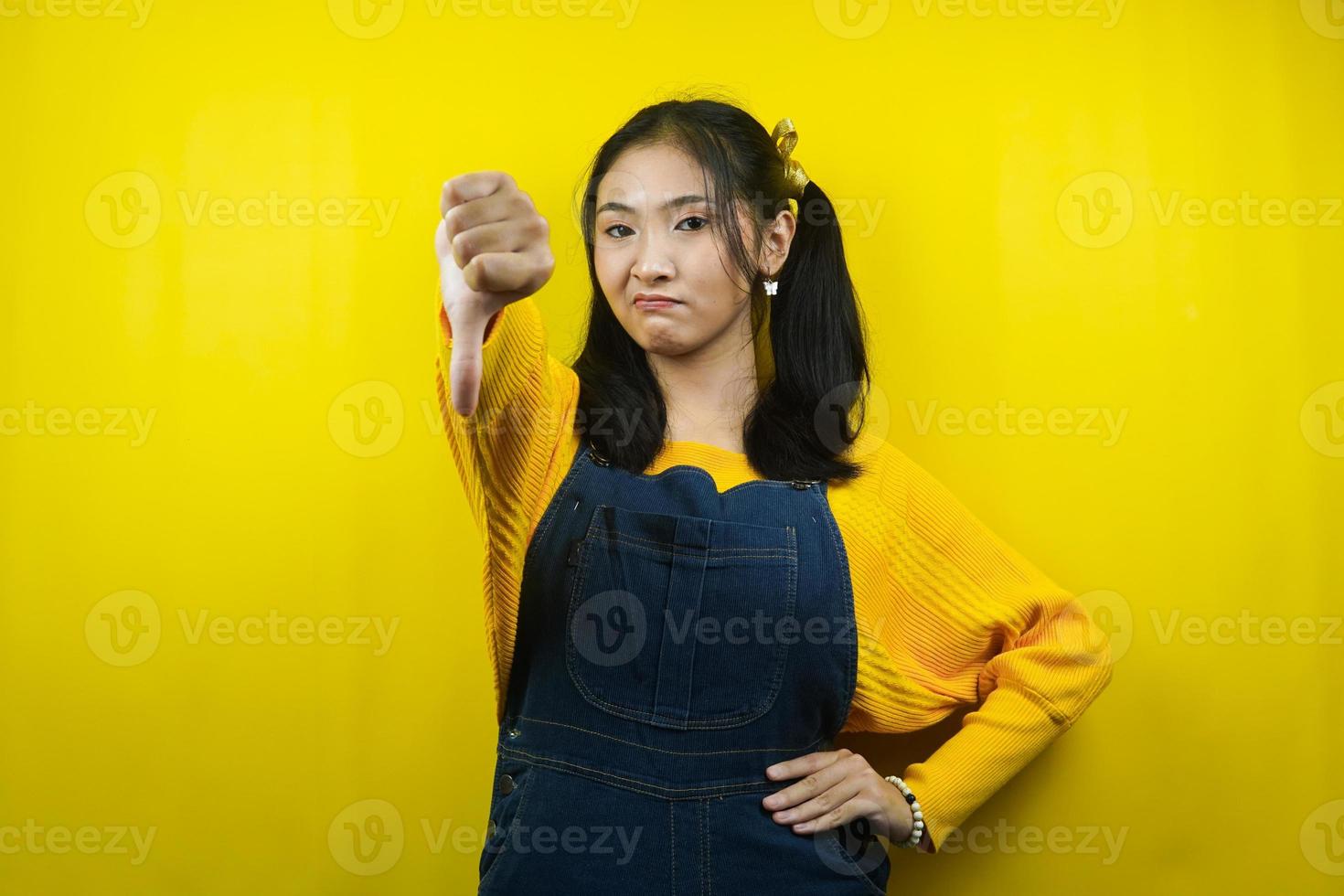 Pretty and cute young woman with dislike sign, angry, displeased, mocking sign, isolated photo