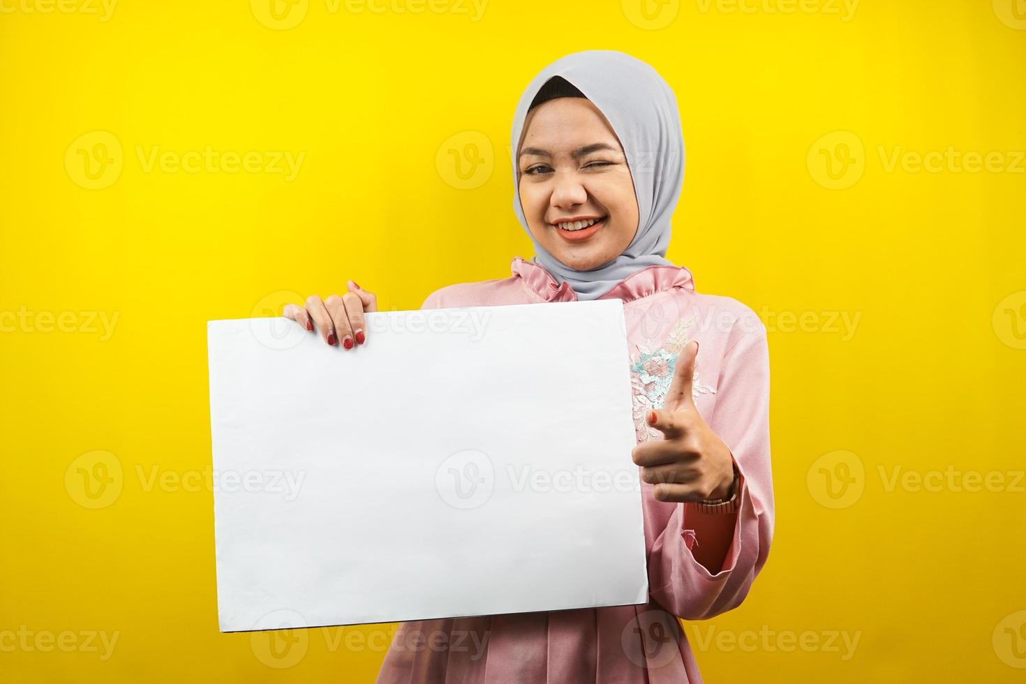 Pretty young muslim woman cheerful holding blank empty banner, placard, white board, blank sign board, white advertisement board, presenting something in copy space, promotion photo