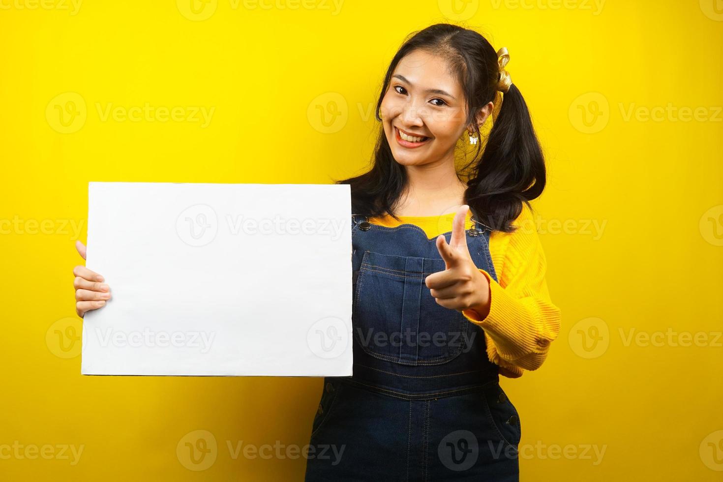 Pretty and cute young woman cheerful holding blank empty banner, placard, white board, blank sign board, white advertisement board, presenting something in copy space, promotion photo