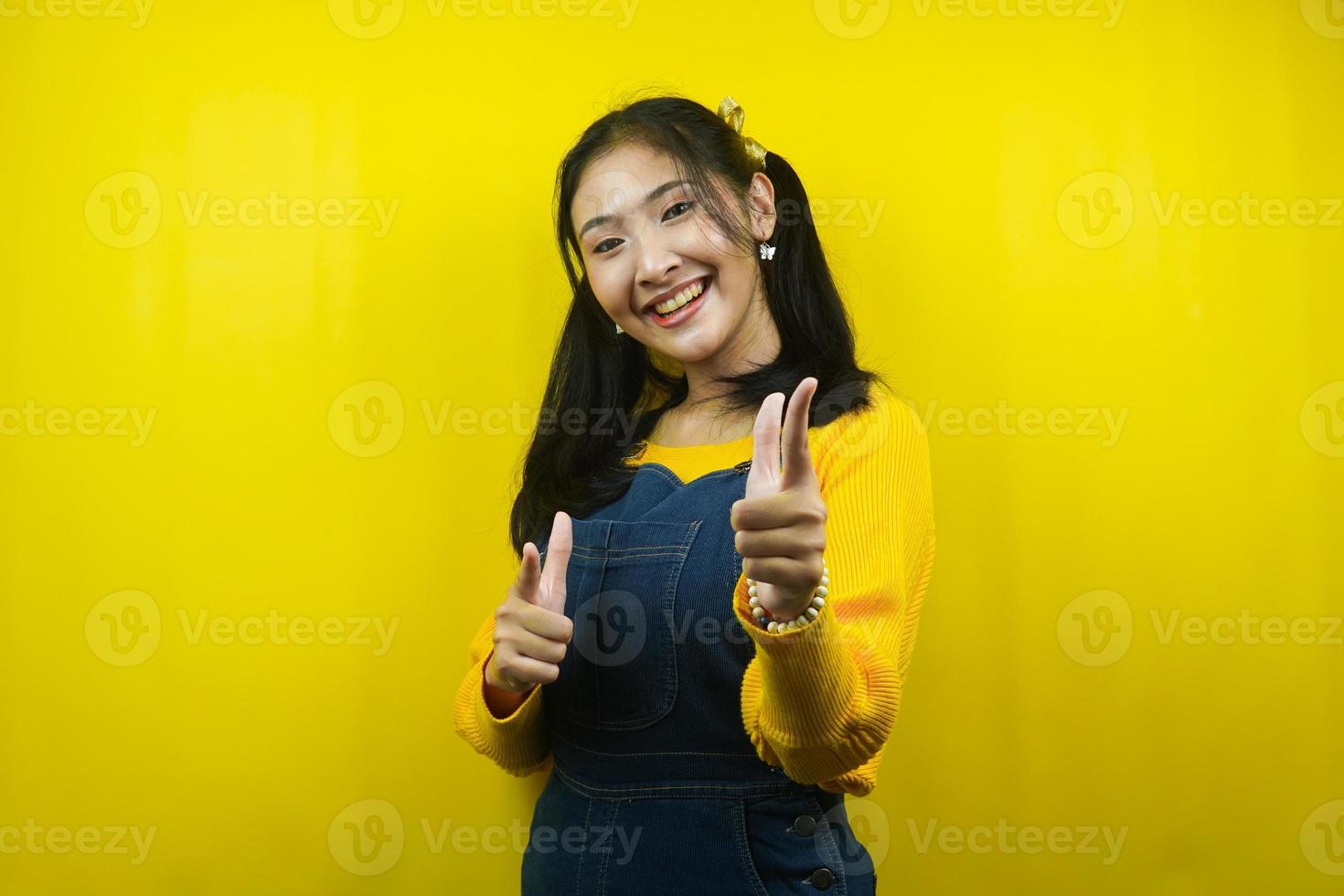 Pretty and cute young woman cheerful, confident, hand pointing at camera, hand pointing at audience, isolated photo