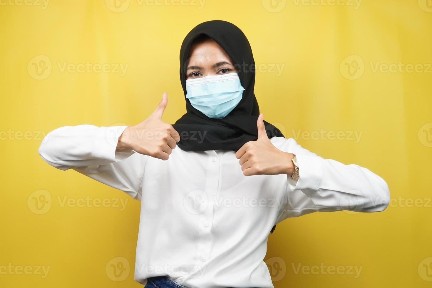 Muslim woman wearing medical masks, anti corona virus movement, anti covid-19 movement, health movement using masks, with hands showing ok sign, good work, success, victory, isolated photo