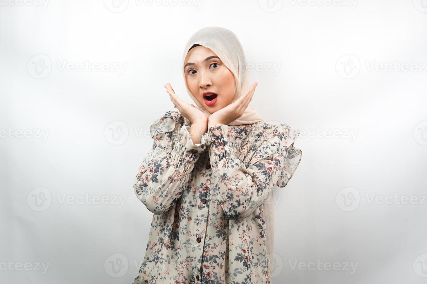 Beautiful young asian muslim woman shocked, surprised, wow expression, with hand holding cheek facing camera isolated on white background photo