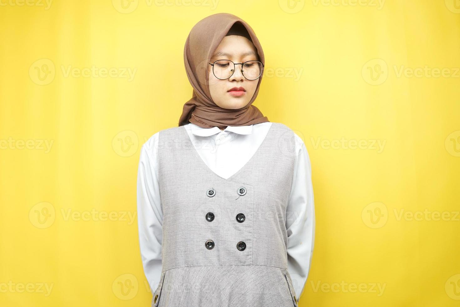 Beautiful asian young muslim woman pouting, disappointed, unhappy, dissatisfied, isolated on yellow background photo