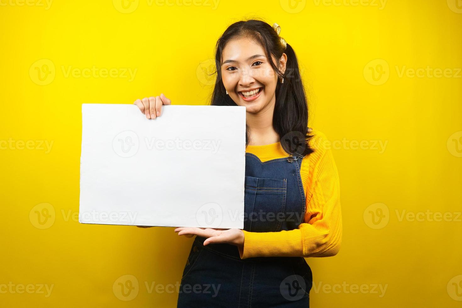 Pretty and cute young woman cheerful holding blank empty banner, placard, white board, blank sign board, white advertisement board, presenting something in copy space, promotion photo