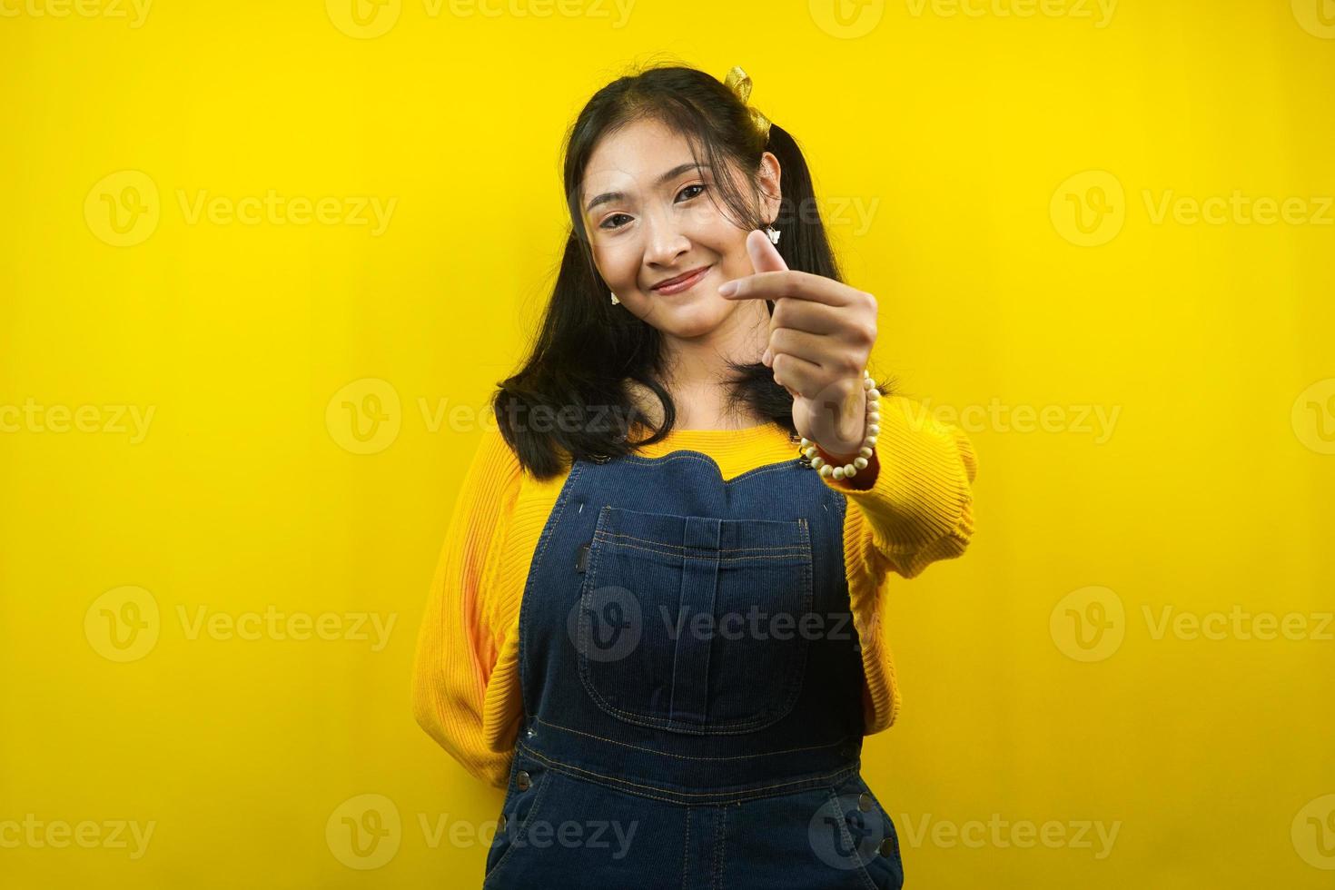Pretty and cute young woman cheerful, cute, with korean love sign hand, isolated photo