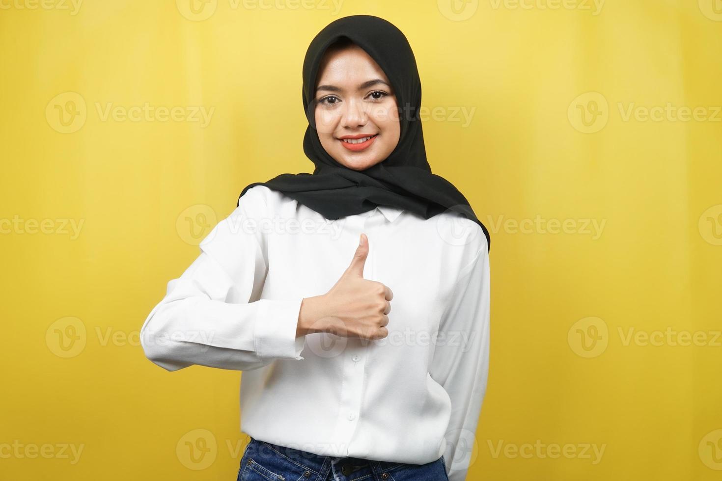 Hermosa joven musulmana asiática con pulgares arriba mano, signo de ok, buen trabajo, éxito, felicitaciones, victoria, sonriendo confiado, entusiasta y alegre, mirando a cámara aislada foto