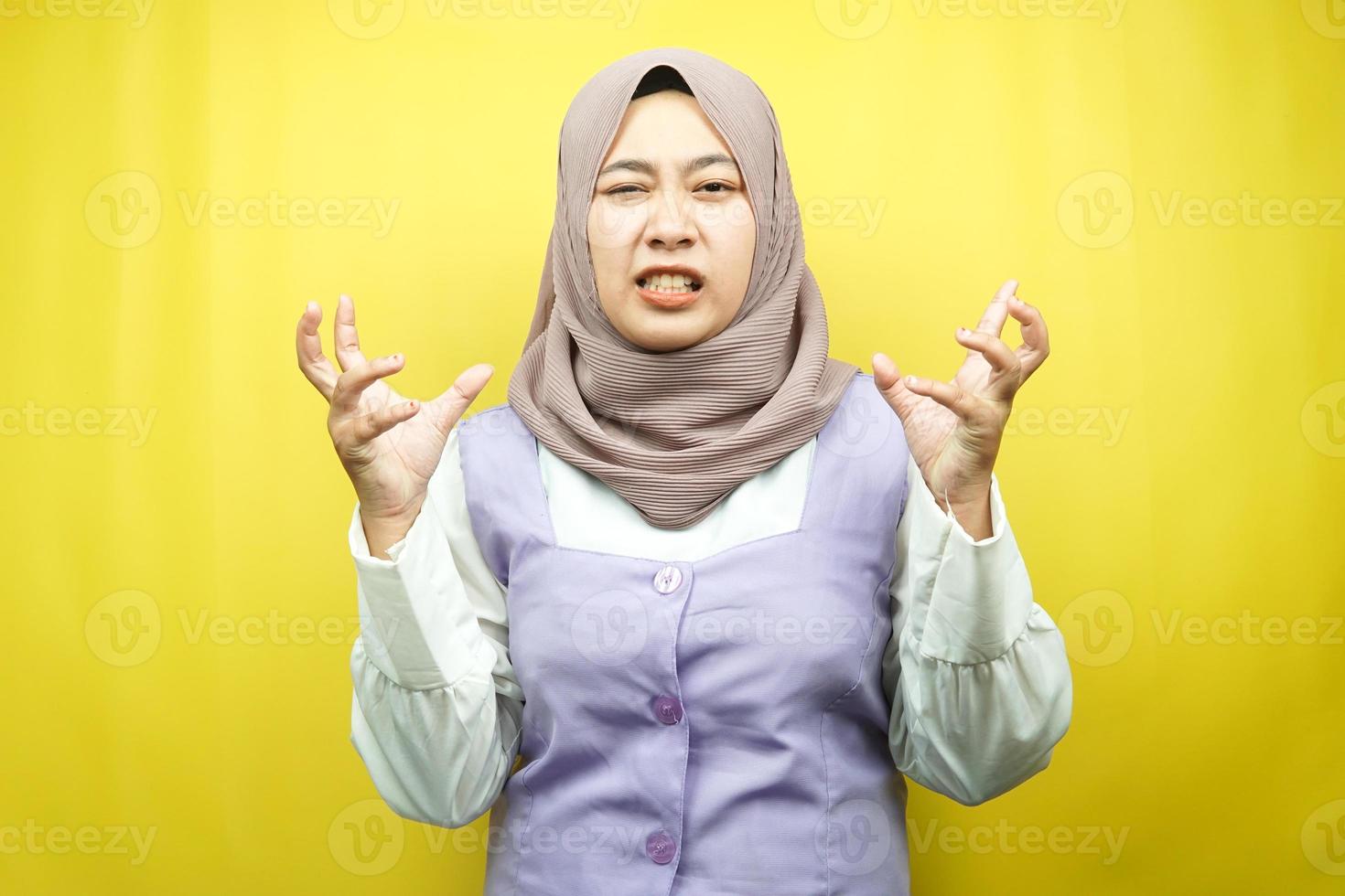Beautiful young asian muslim woman shocked, dizzy, stressed, unhappy, many problems, want solution, with hands up isolated on yellow background photo