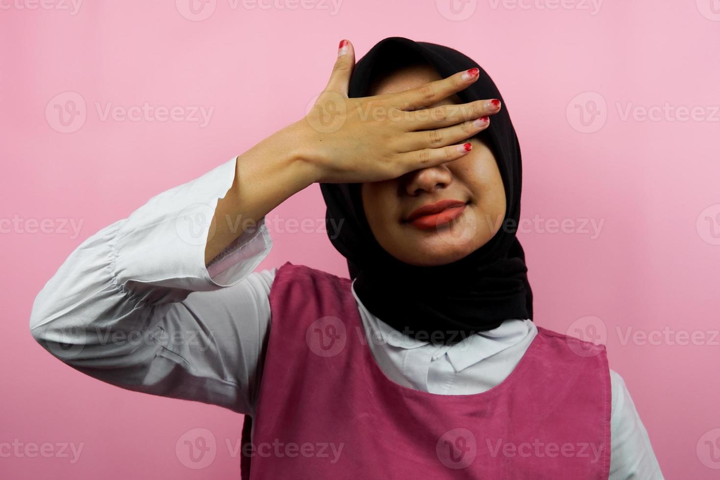Closeup of beautiful young Muslim woman closing her eyes isolated photo