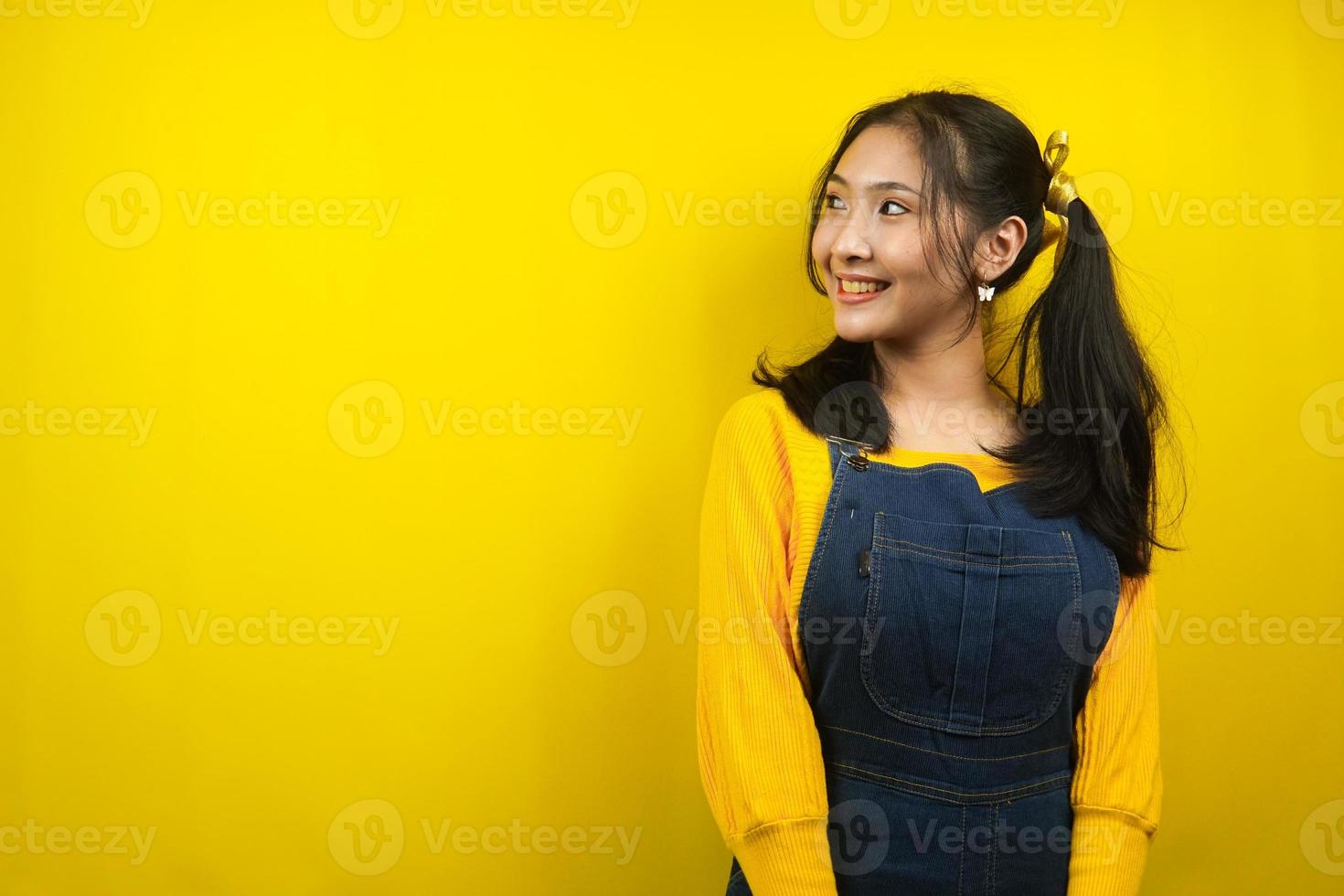 Pretty and cute young woman cheerful, cute, looking at empty space, presenting something, promoting products, advertising, isolated photo