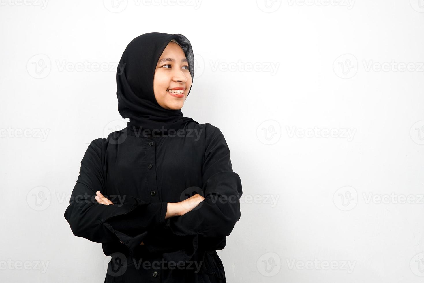 Beautiful young asian muslim woman confident and cheerful looking empty space presenting something, isolated on white background photo