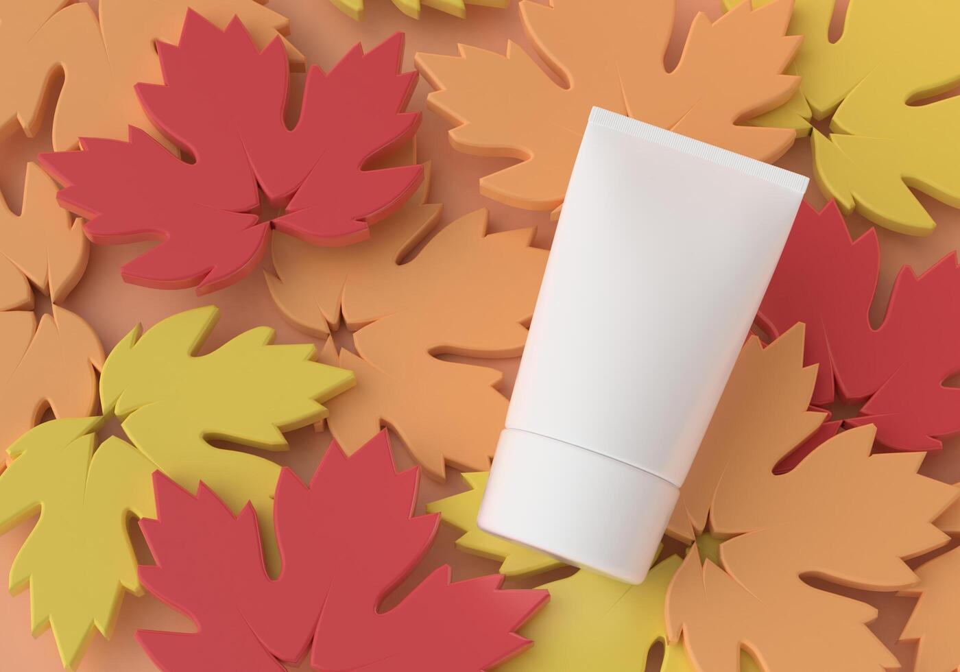 Squeeze tube for applying cream or makeup on a maple leaf background. photo