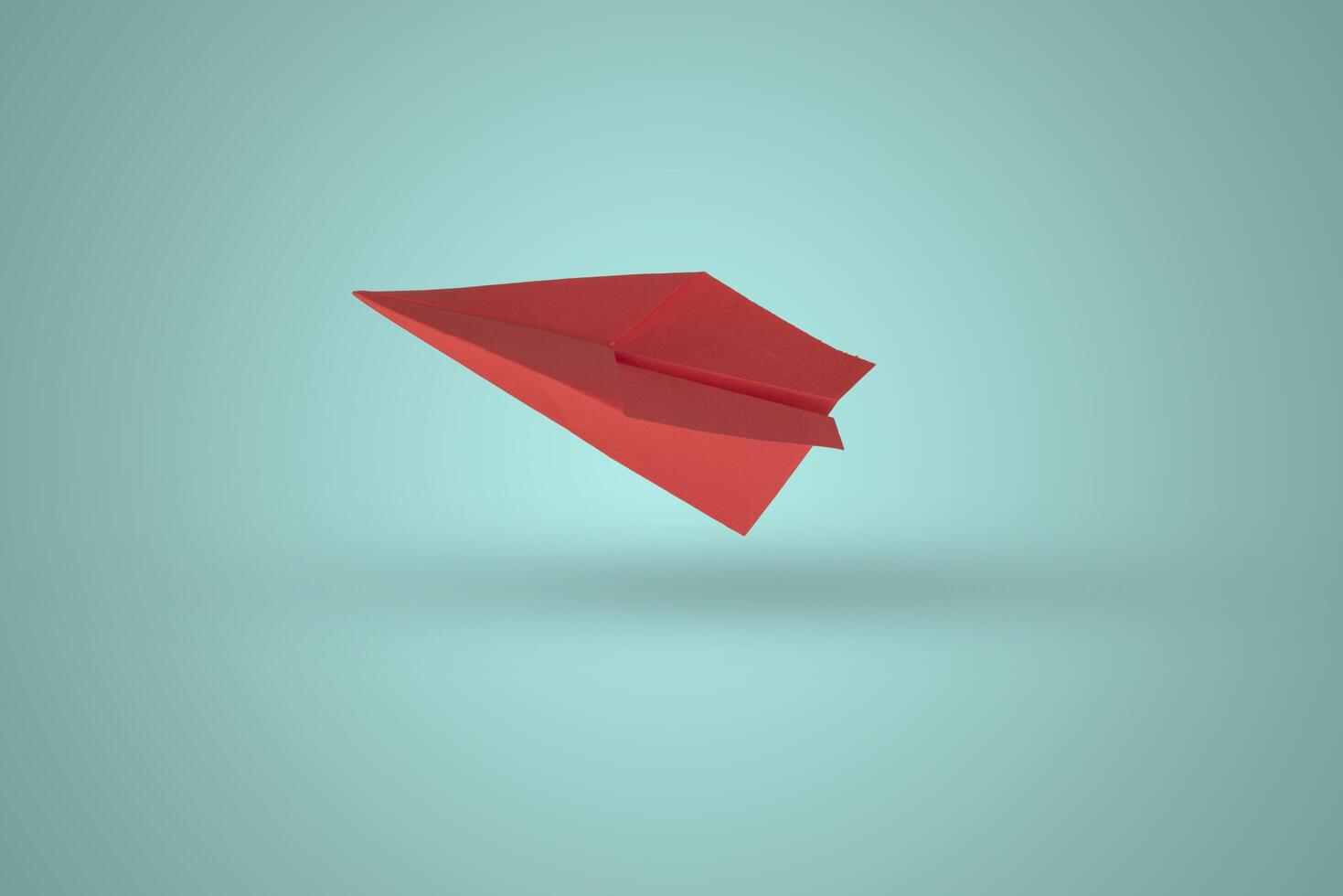 Paper plane on color background photo