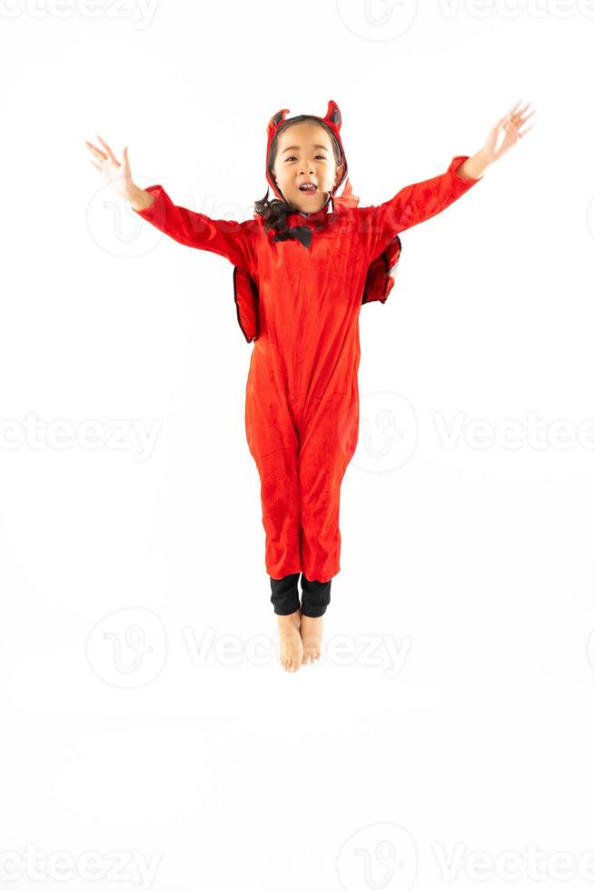 Portrait Asian little cute girl in evil costume for Halloween festival with pumpkin photo