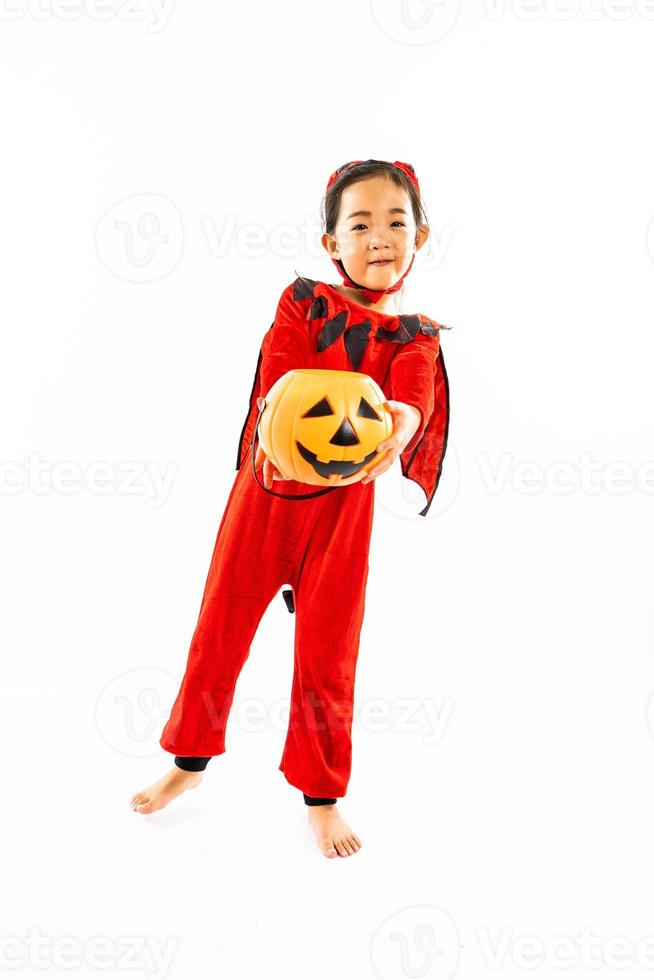 Portrait Asian little cute girl in evil costume for Halloween festival with pumpkin photo