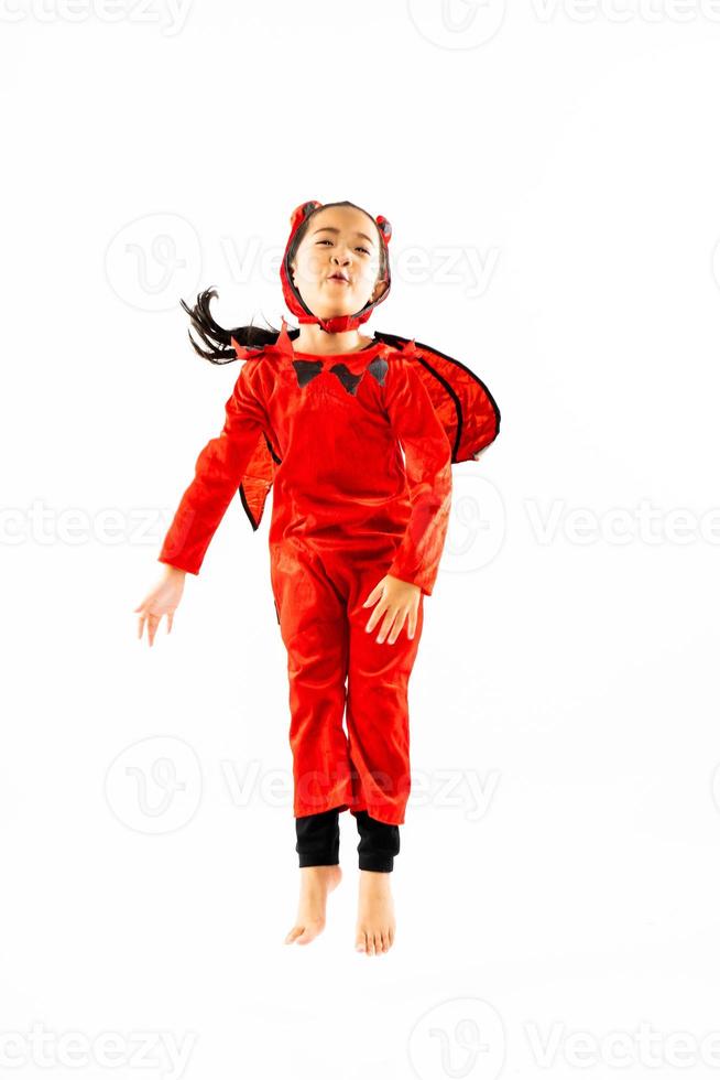 Portrait Asian little cute girl in evil costume for Halloween festival with pumpkin photo