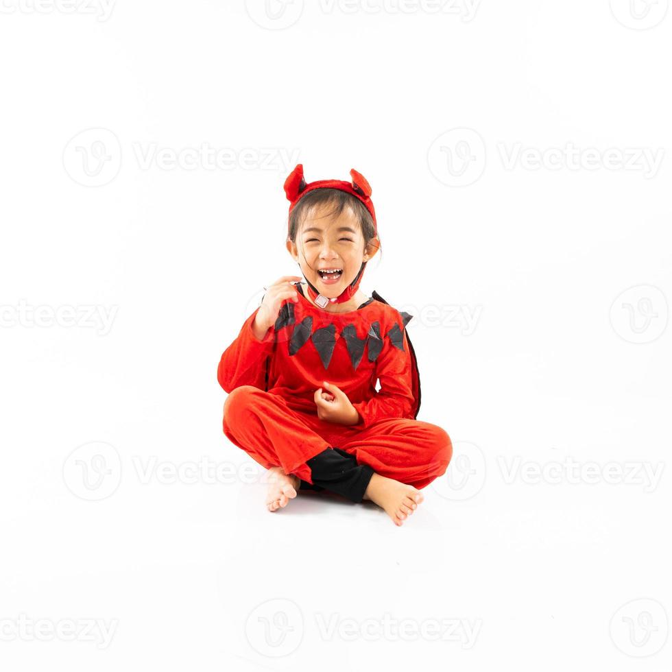 Portrait Asian little cute girl in evil costume for Halloween festival with pumpkin photo