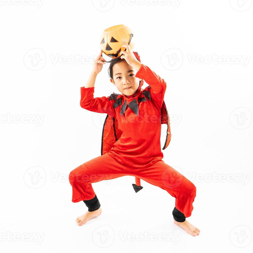 Portrait Asian little cute girl in evil costume for Halloween festival with pumpkin photo