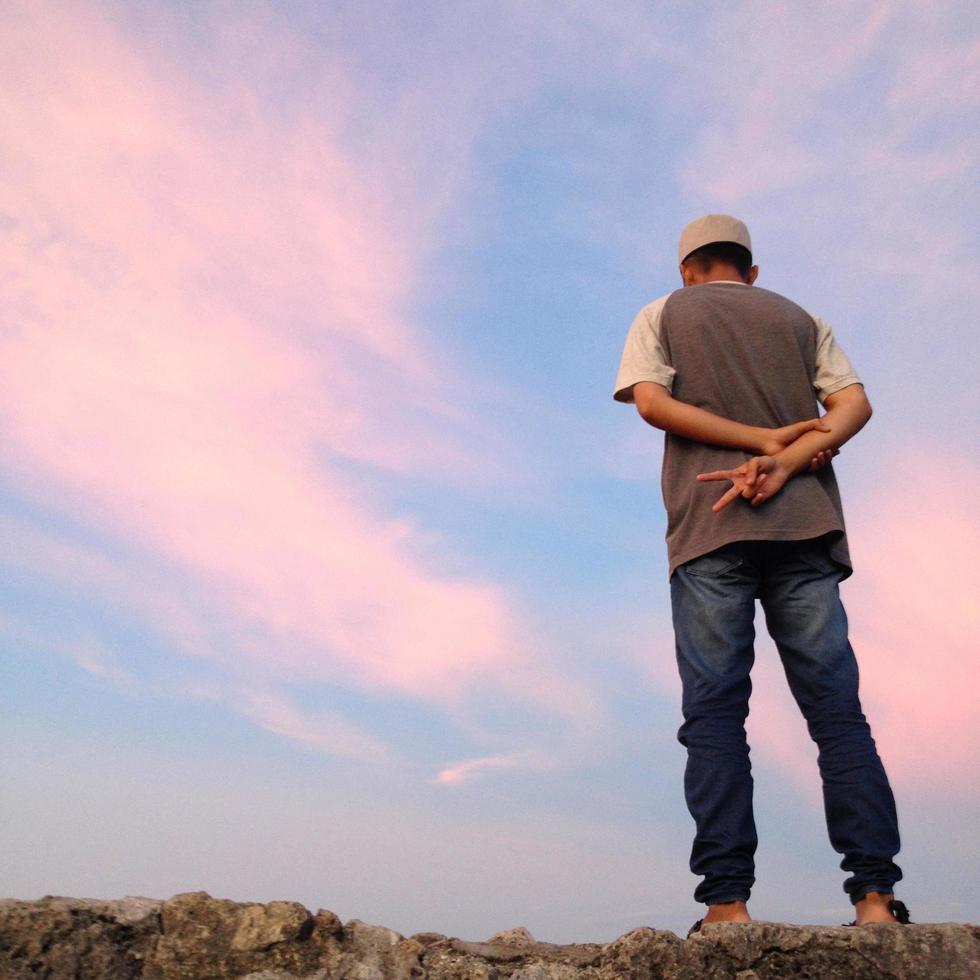 defocused on a man back view against an orange sky background. photo