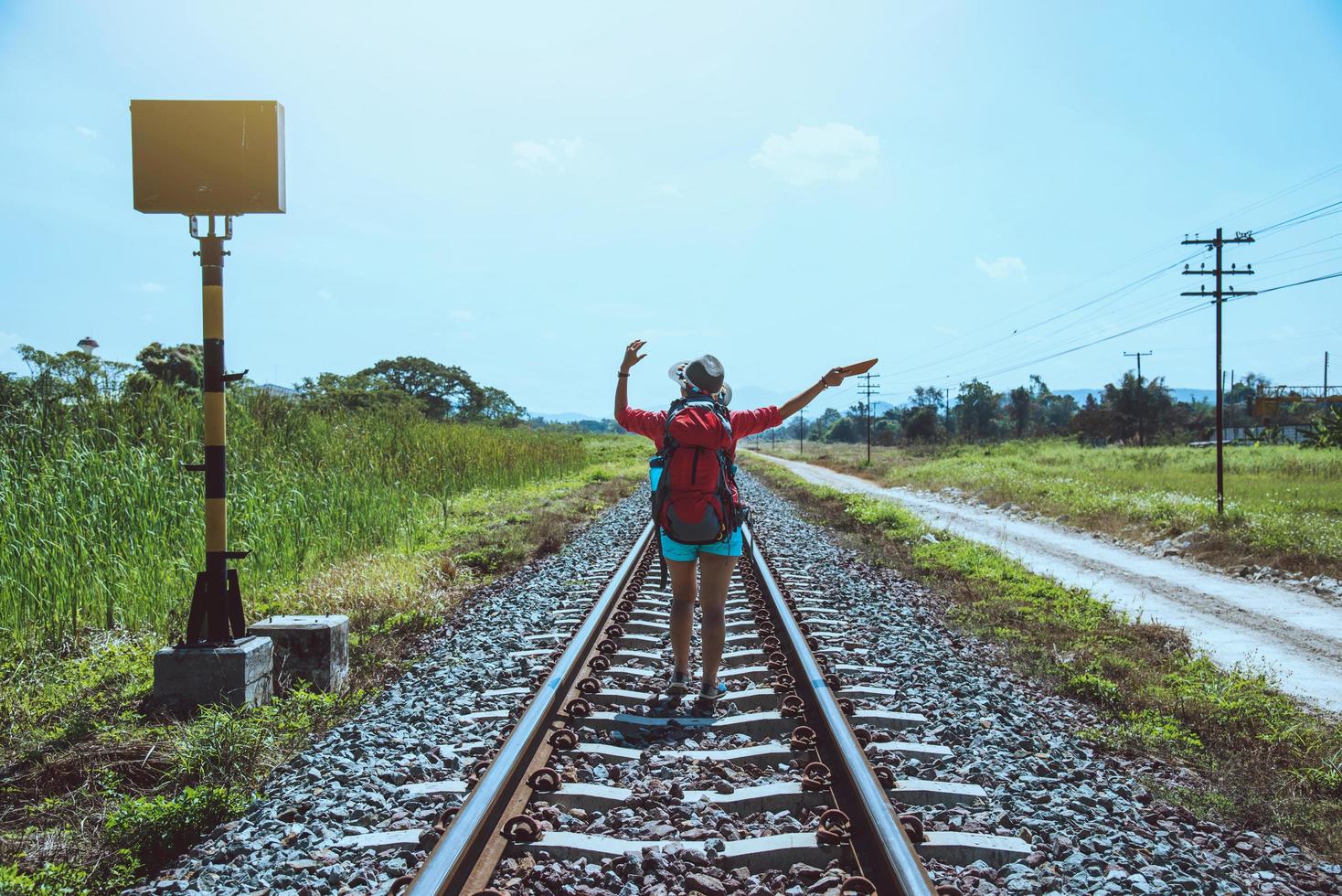 Asian women travel countryside. Travel relax. bag backpack travel. Walk on the railroad. Thailand photo