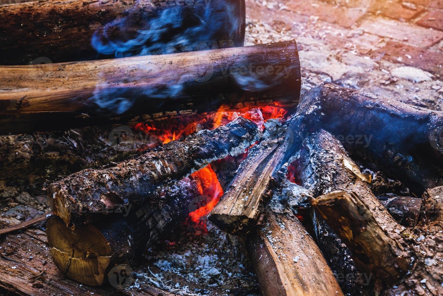 A burning bonfire flame fire in nature . bokeh from the fire blurred backgrounds photo