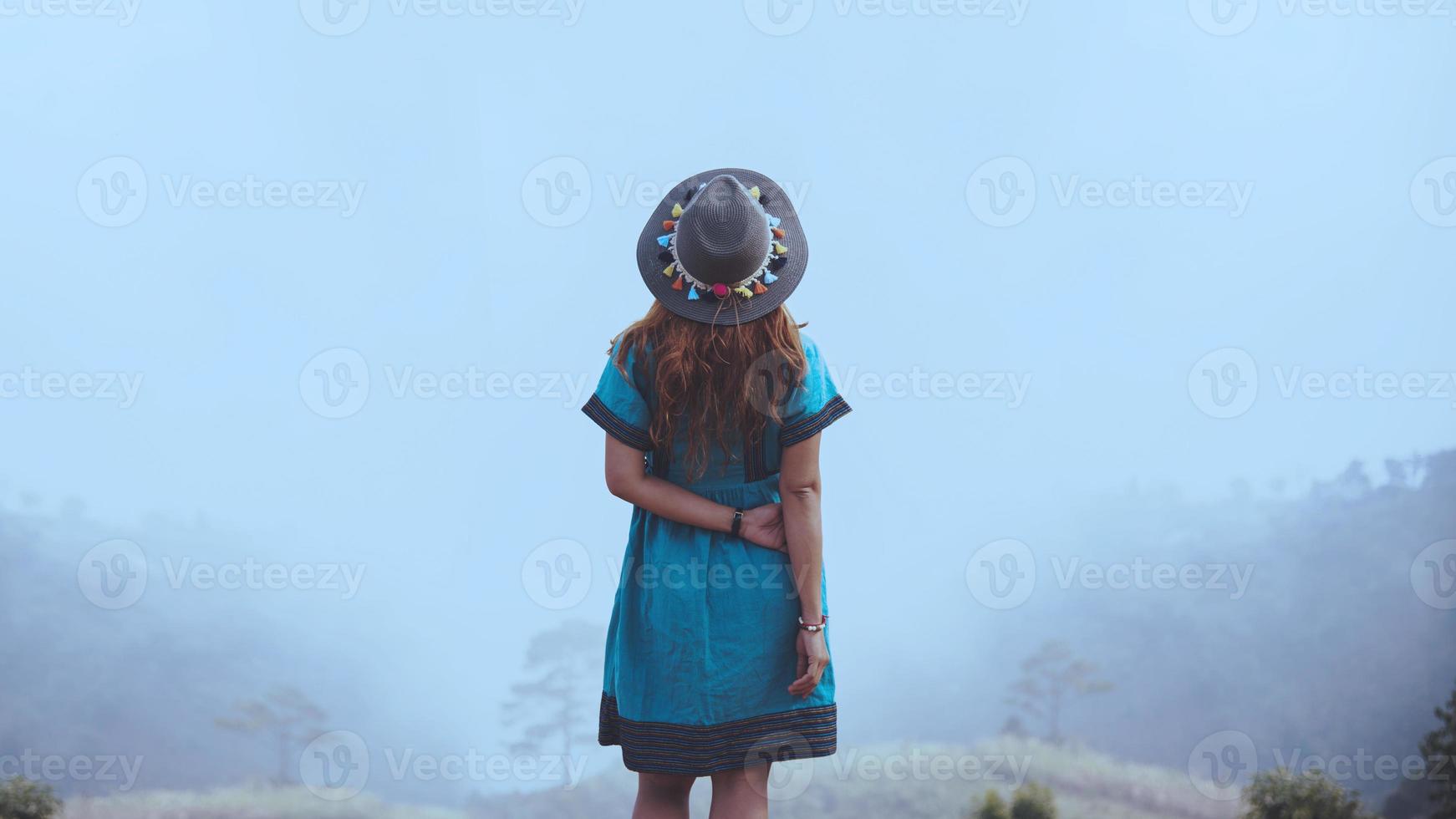 Women wear tribal costumes. Mountain view with foggy mountains. photo