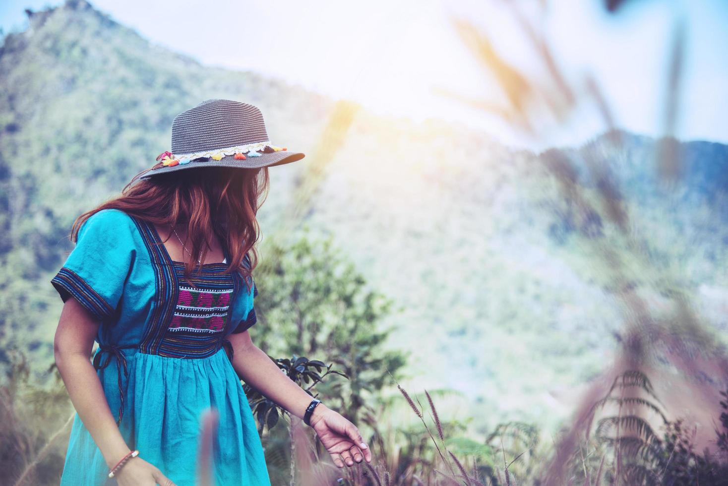 Women wear tribal costumes. Mountain view with foggy mountains. photo