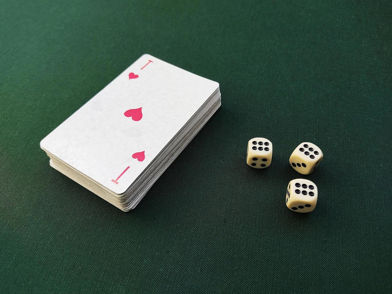 The ace of hearts lies on top of the deck of playing cards. photo