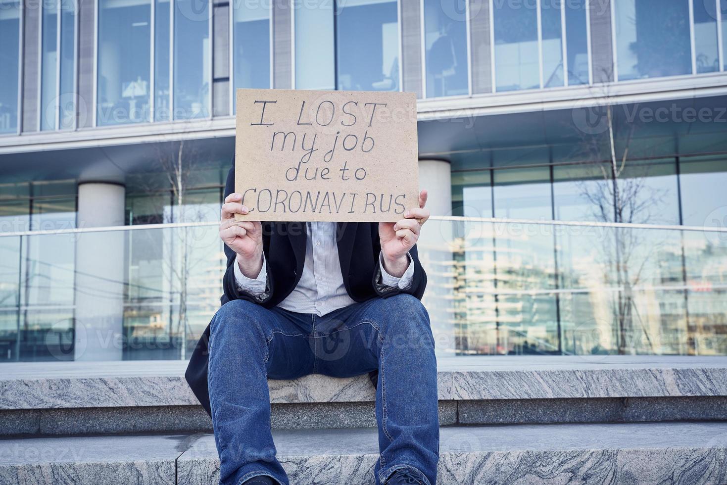 Job loss due to COVID-19 virus pandemic concept. Unrecognizable man holds sign I lost my job photo