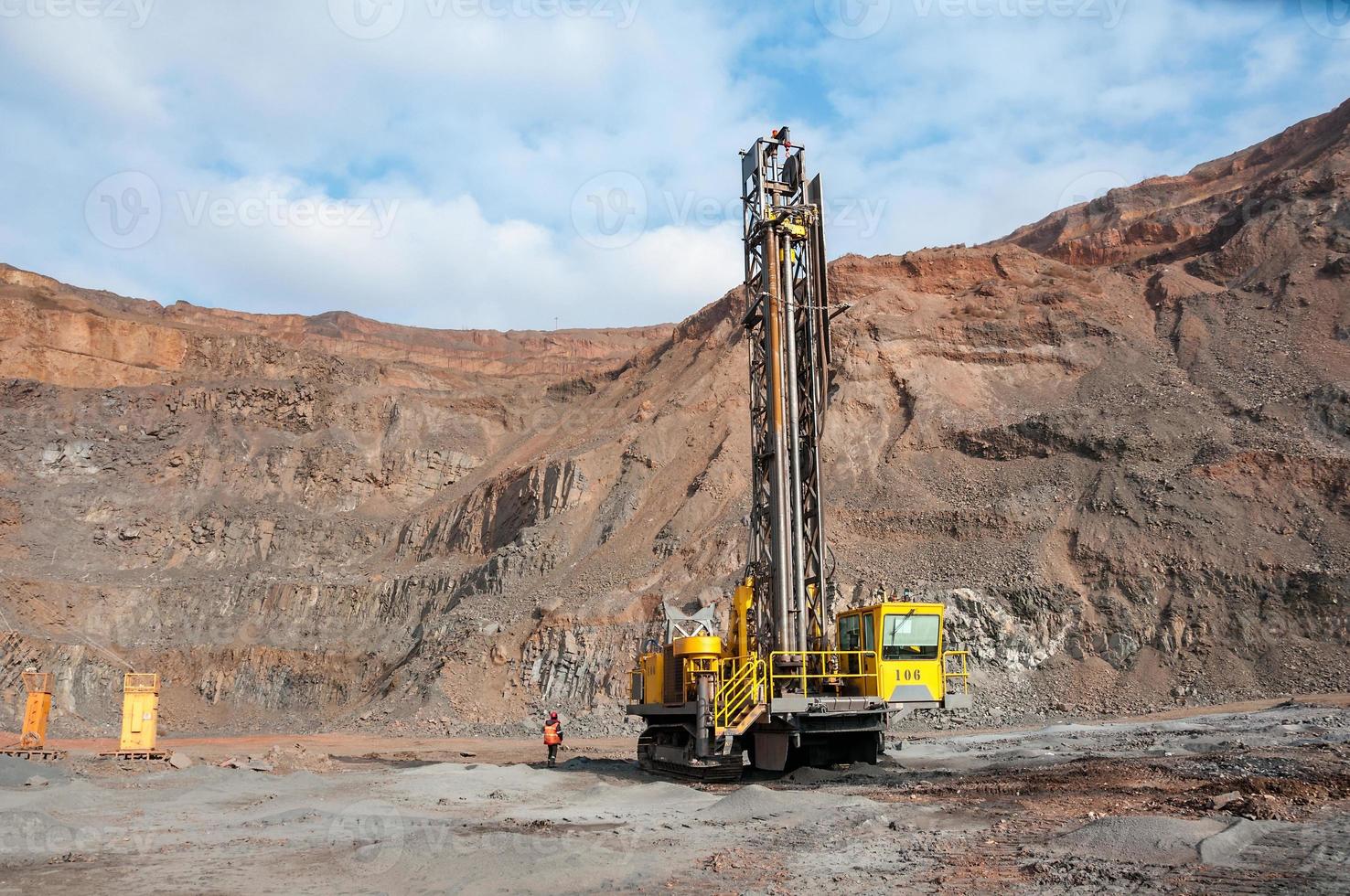 open cast mine dump trucks drive alone industrial area of iron ore quarry photo