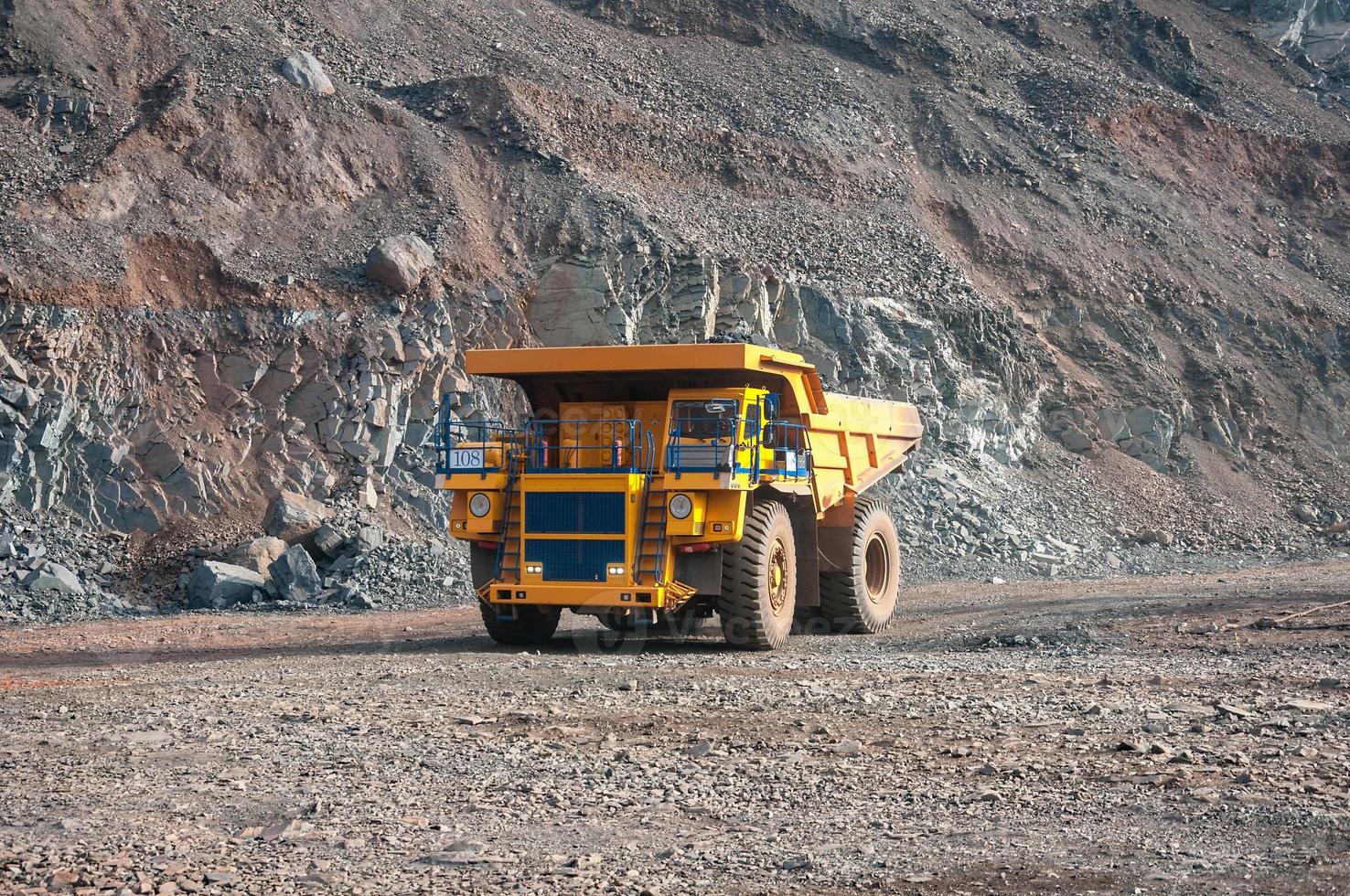 open cast mine dump trucks drive alone industrial area of iron ore quarry photo