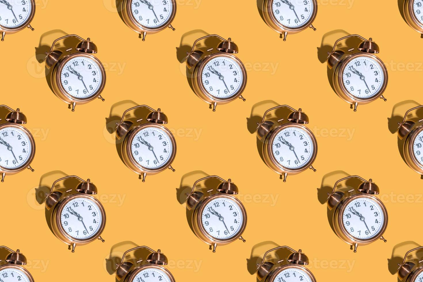 Alarm clock on a colored background hard shadows. Close up. Seamless patterns photo