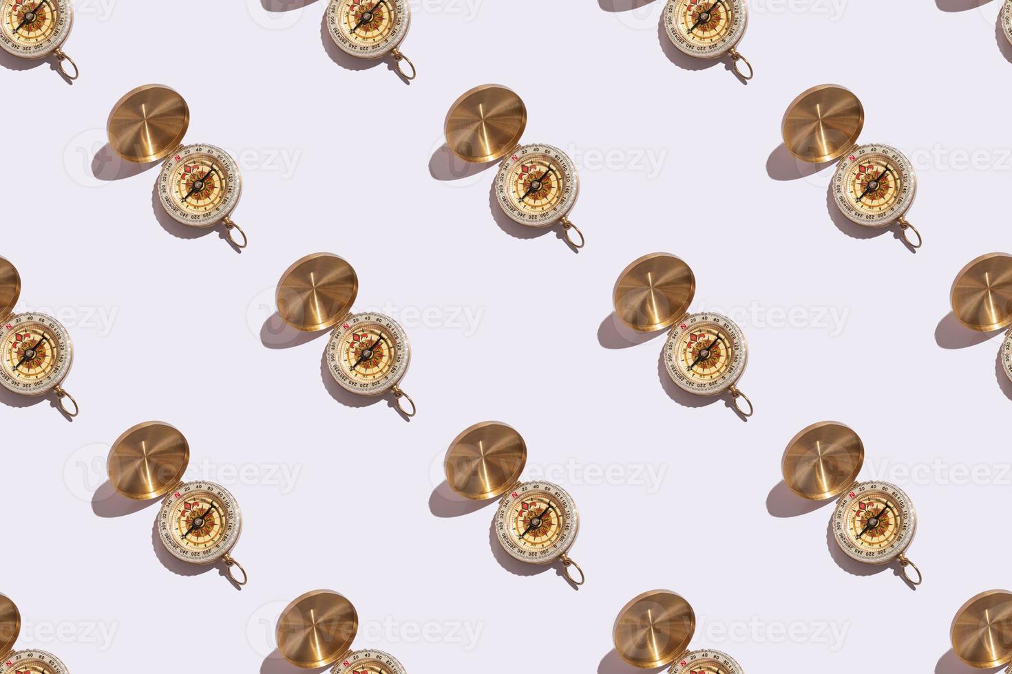 compass on white background close-up with hard shadows with copy space. Pattern on white background photo