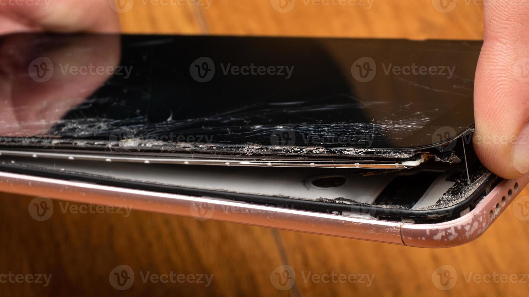 chip crack on the glass of the phone, broken touchscreen smartphone photo