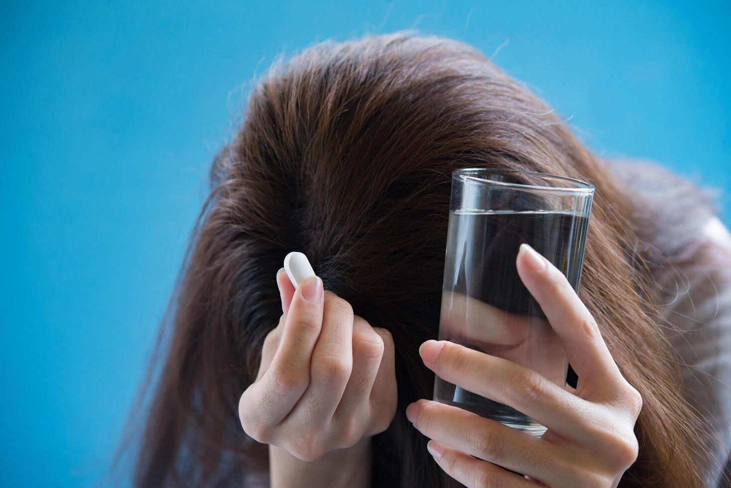 woman hand holding a pills take medicine according to the doctor's order photo