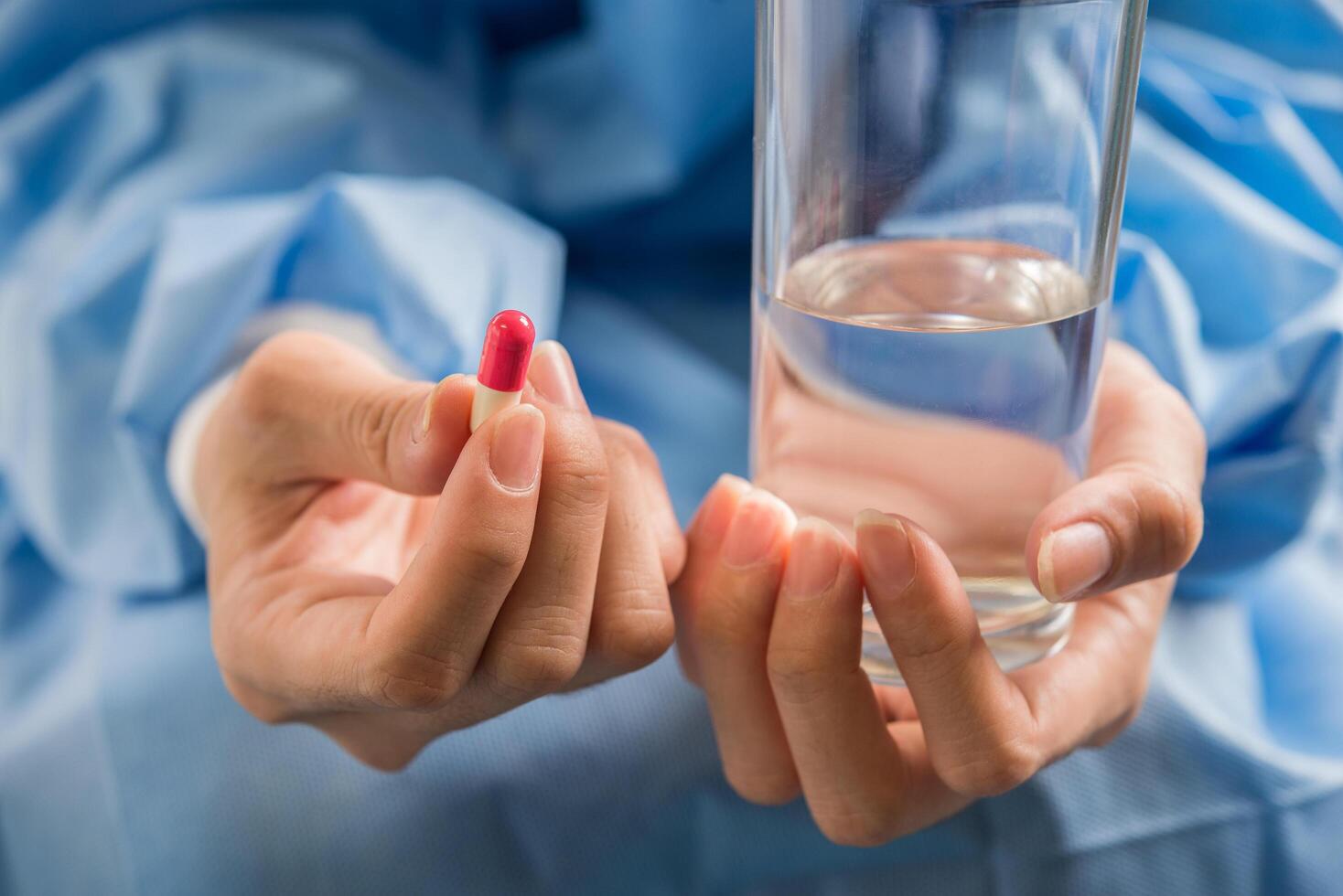 Woman's hand pours the medicine pills out of the bottle photo