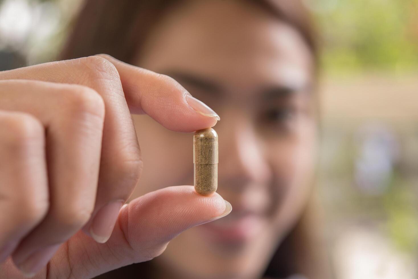 woman hand holding a pills take medicine according to the doctor's order photo