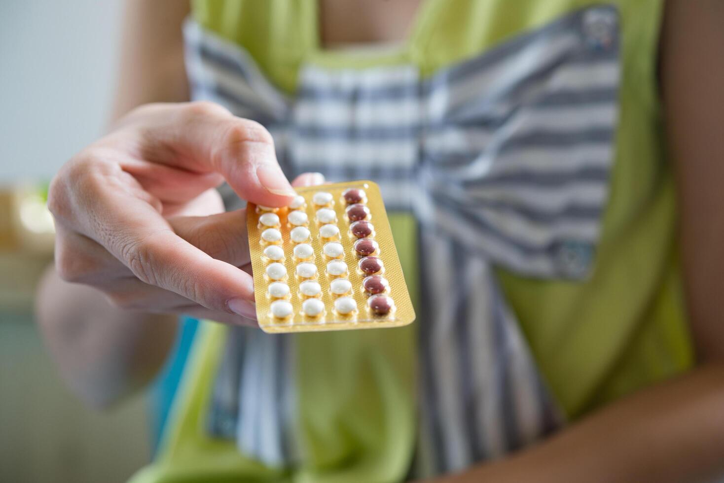 Woman hand holding a contraceptive panel prevent pregnancy photo