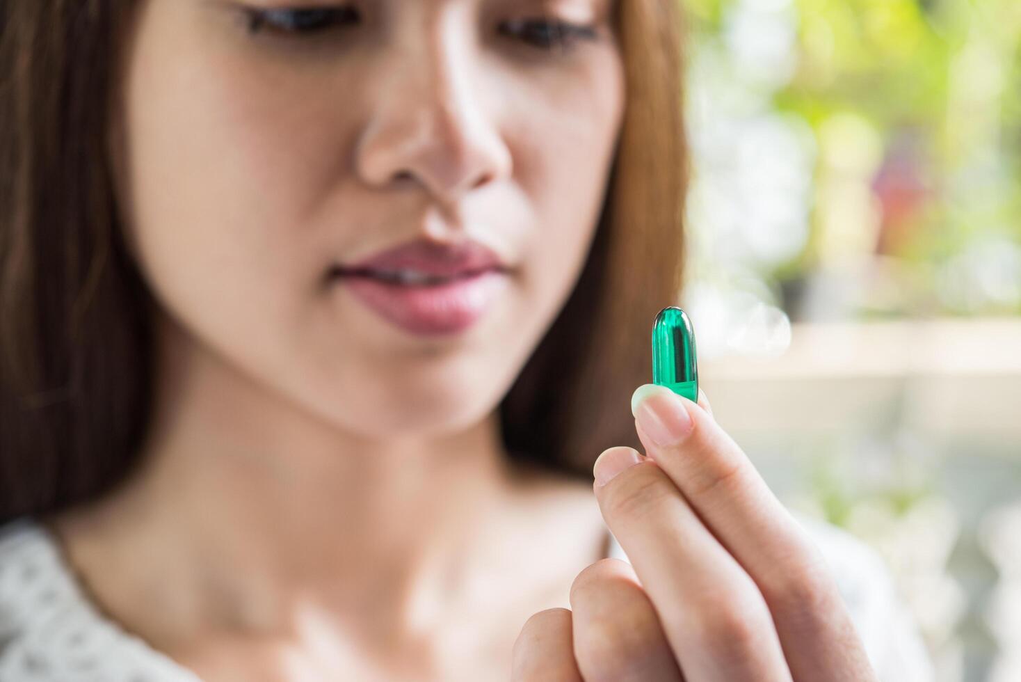 woman hand holding a pills take medicine according to the doctor's order photo