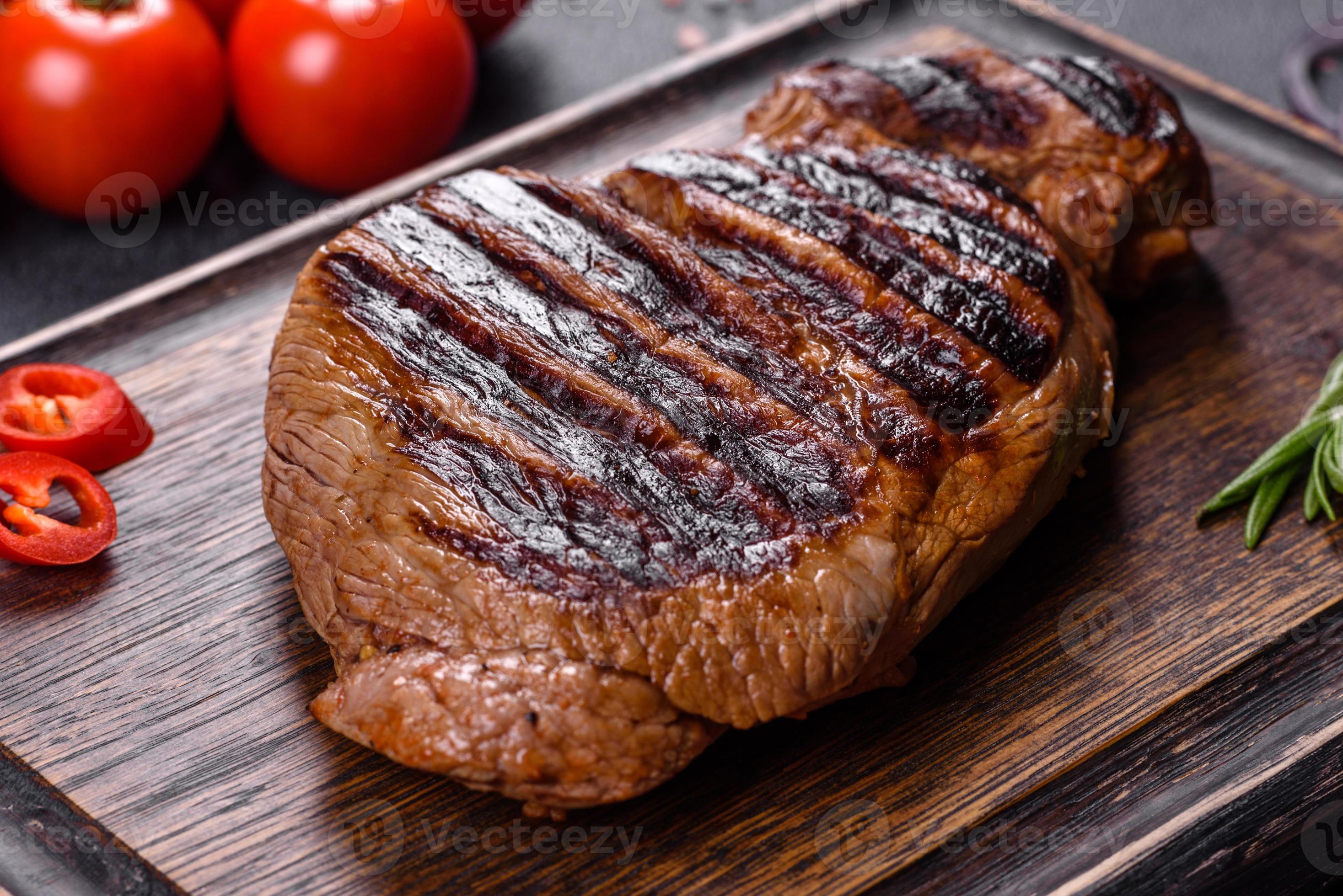 Cooked grilled Chuck eye roll steak on a chopping Board 4768247 Stock