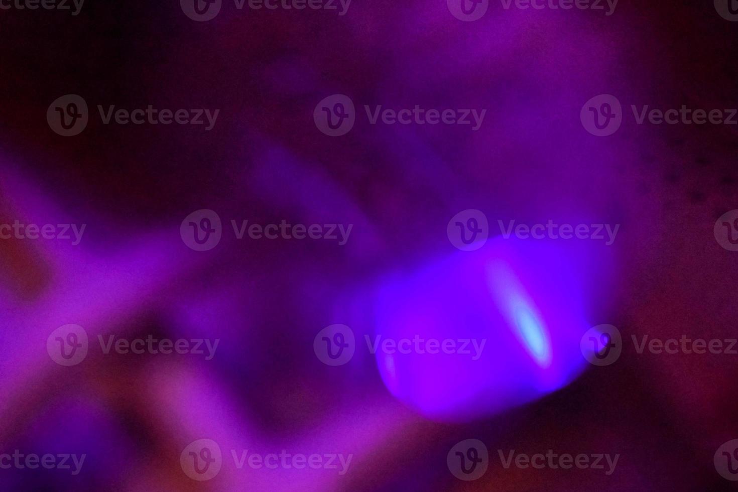 light purple neon light abstract Neon bright lens flare colored on black background.dark abstract futuristic background and Neon photo