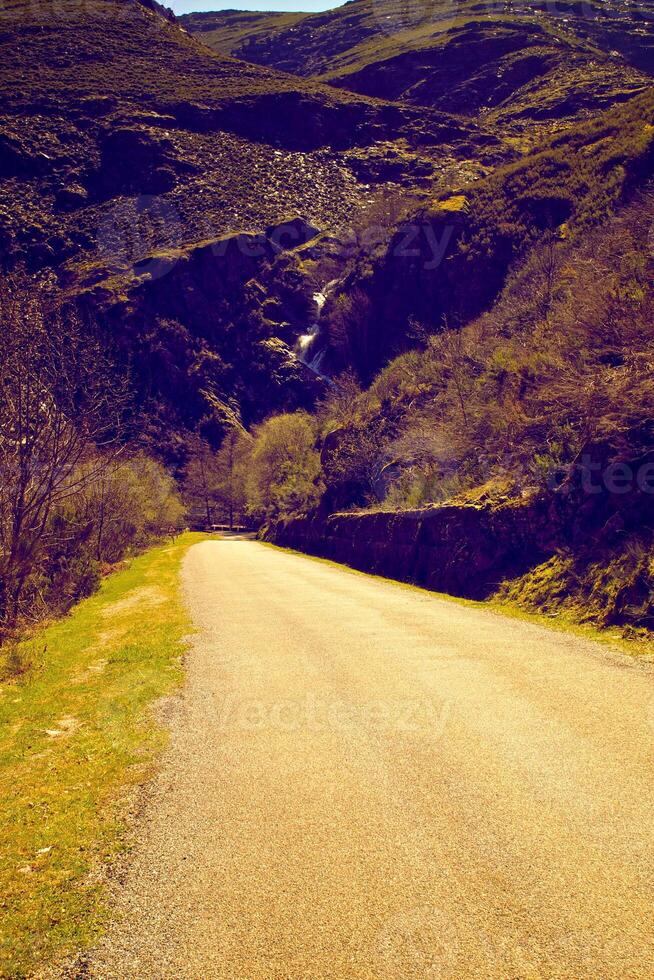 green in the road track beautiful Road turning in the hills and Mountain road grassland road in the evening in. photo