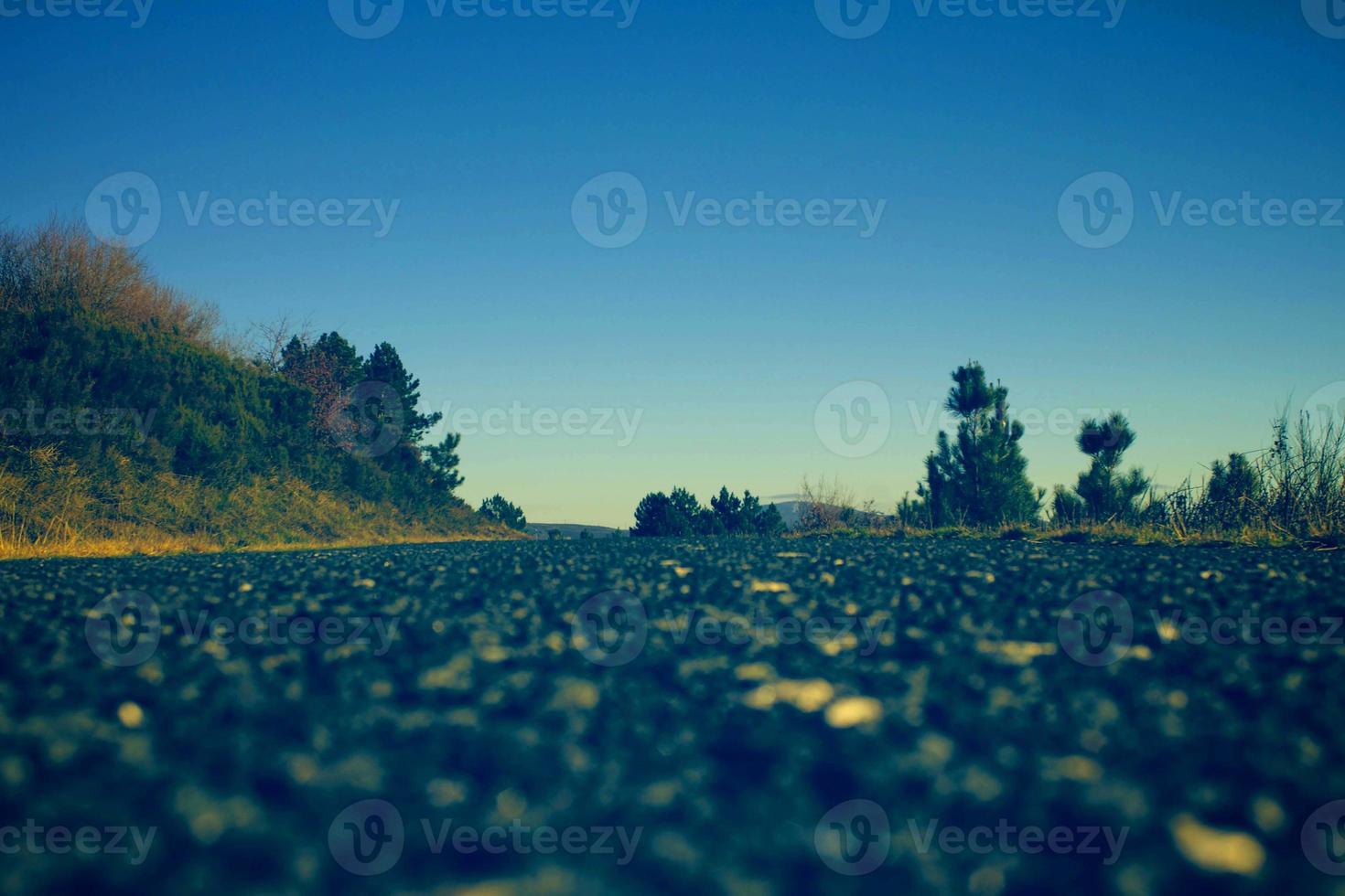 green and sea blue and sky blue beautiful sea and sunset with large yellow sun under the sea surface hills in the background. photo