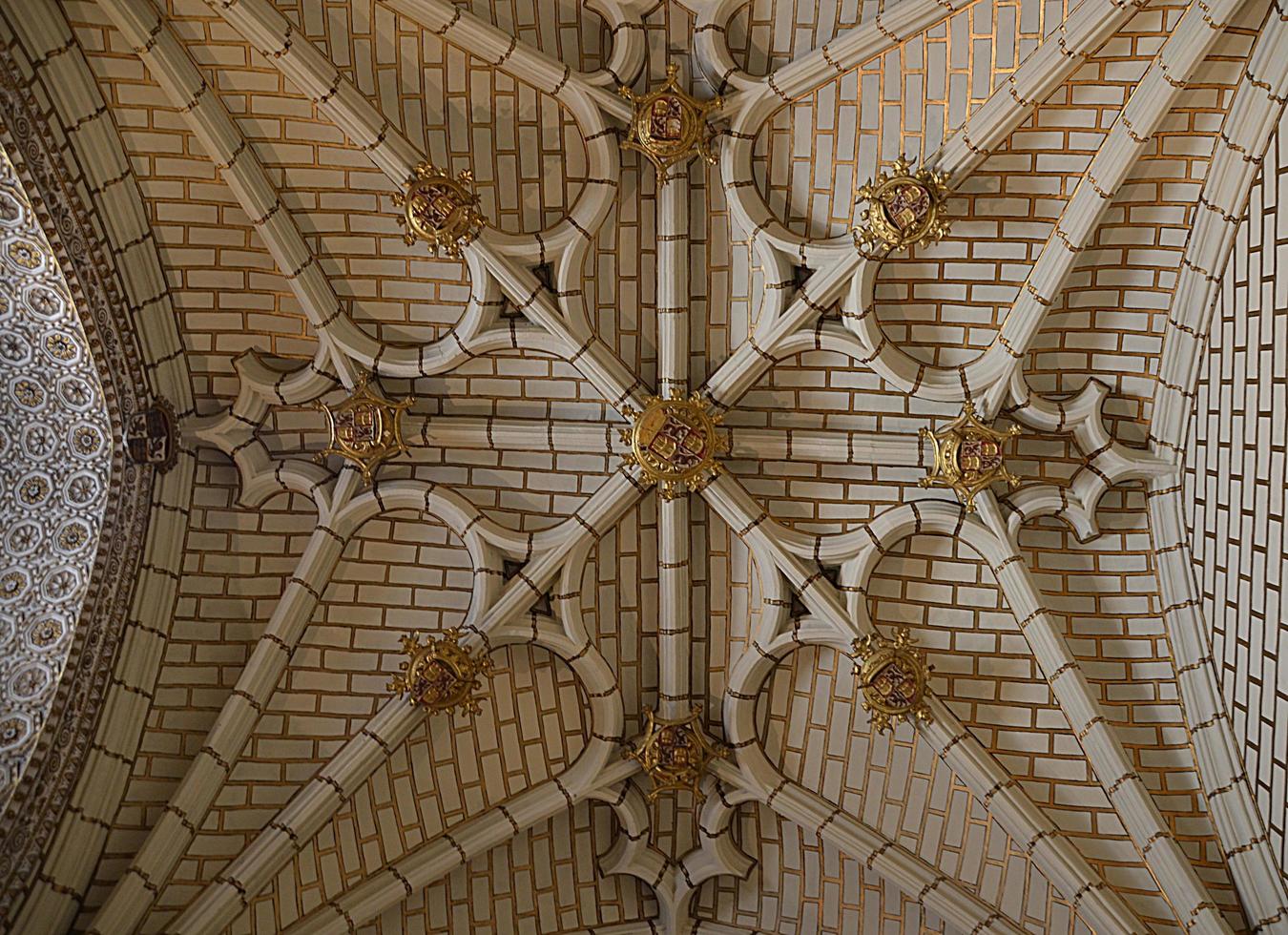 Roof of a building decorated with white bricks, medieval emblems and coats of arms of feudal lords photo