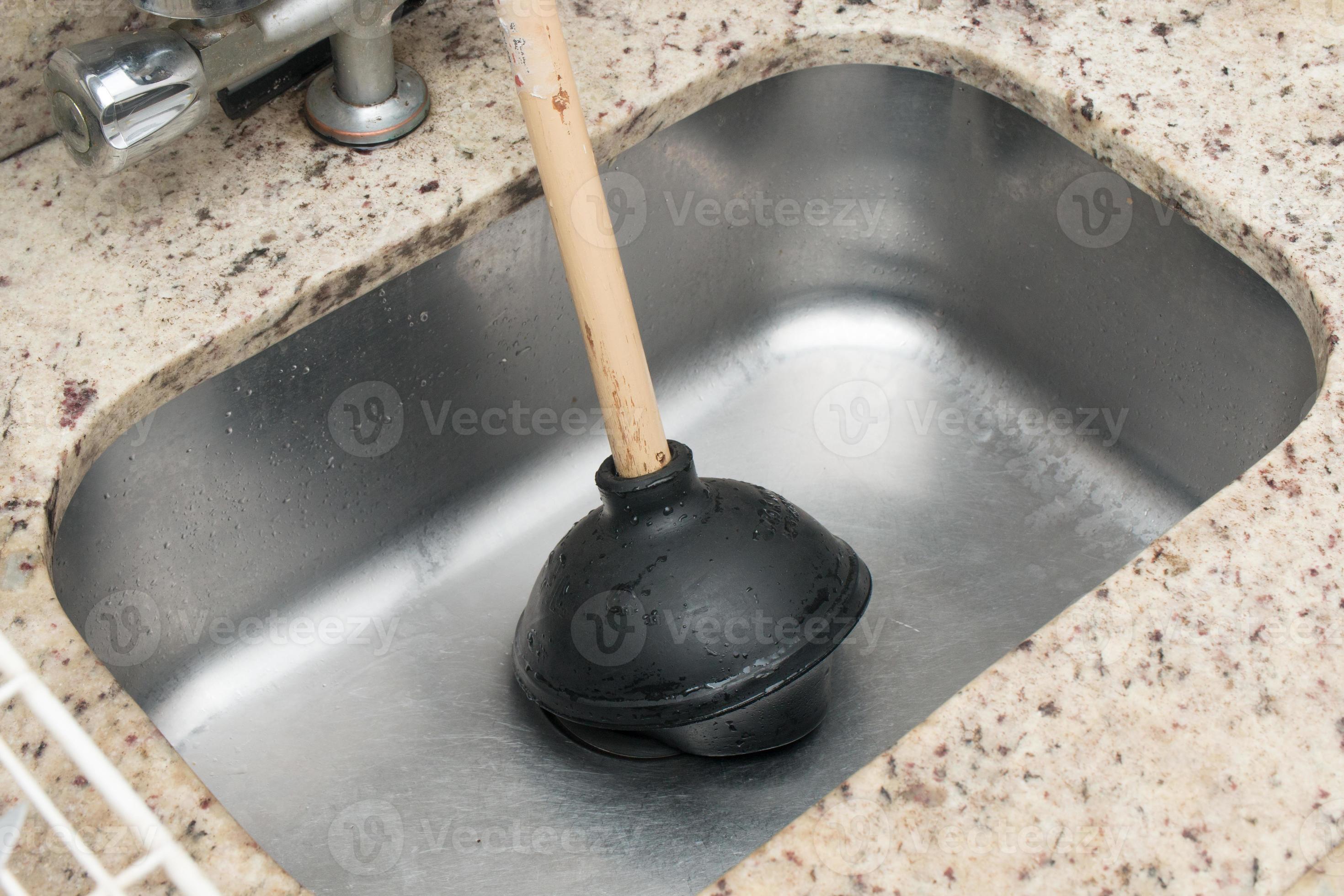 Man Using a Plunger to unstop his kitchen sink 4773754 Stock Photo at  Vecteezy
