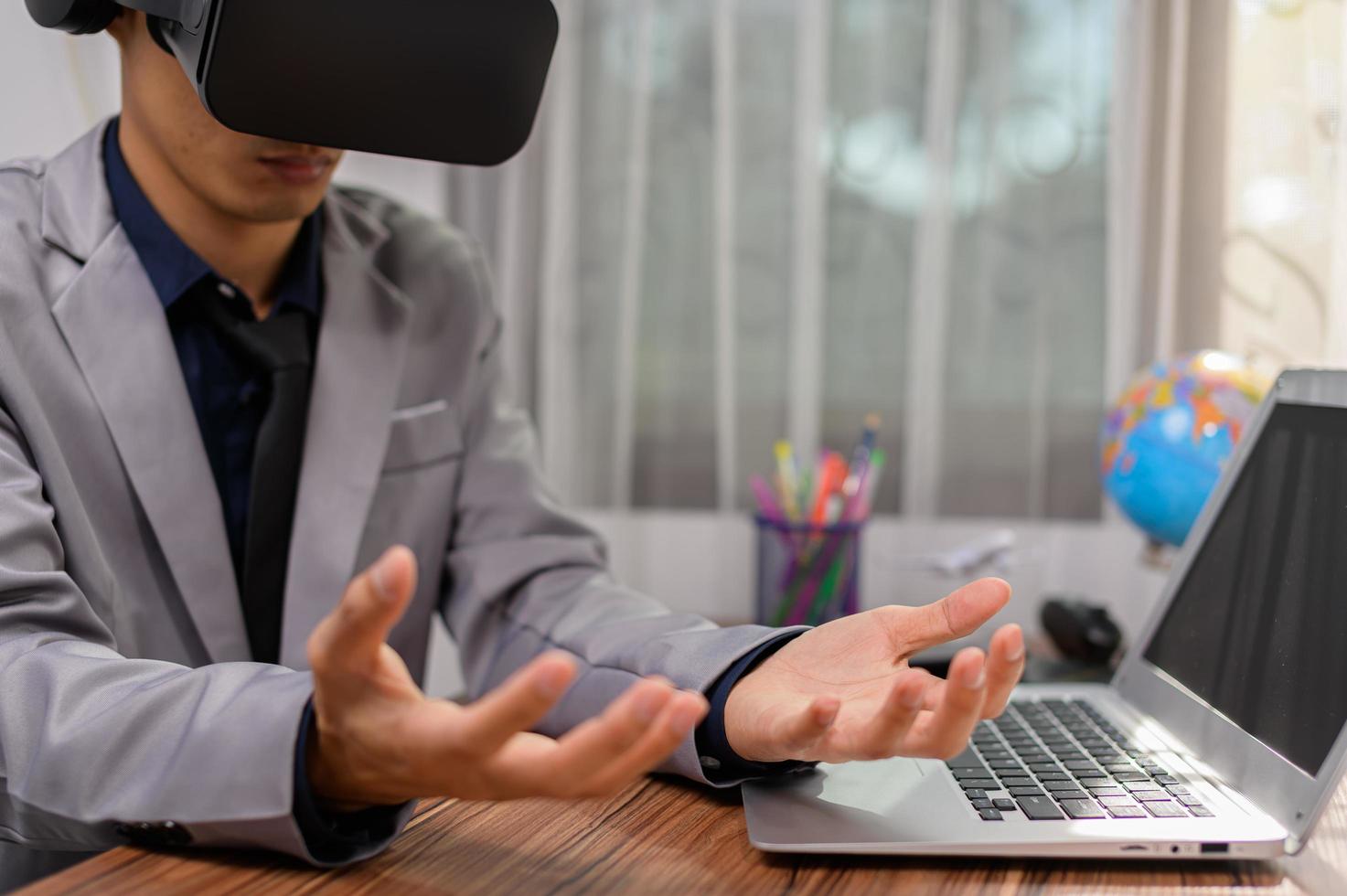 Businessman is using VR glasses to work. Virtual world. photo
