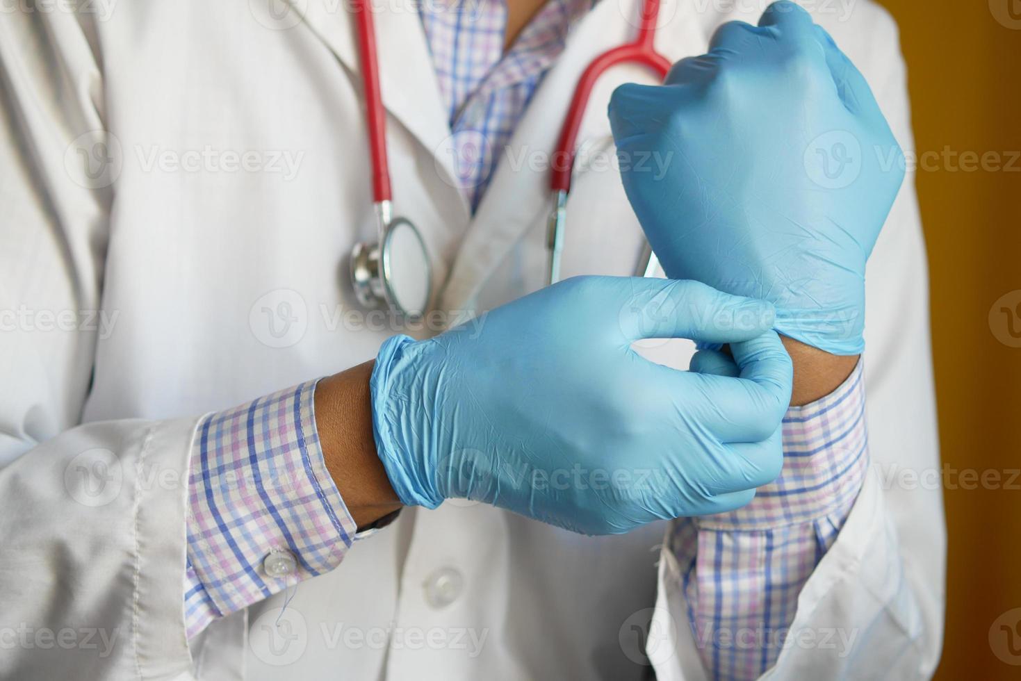 man doctor wears medical gloves, close up photo