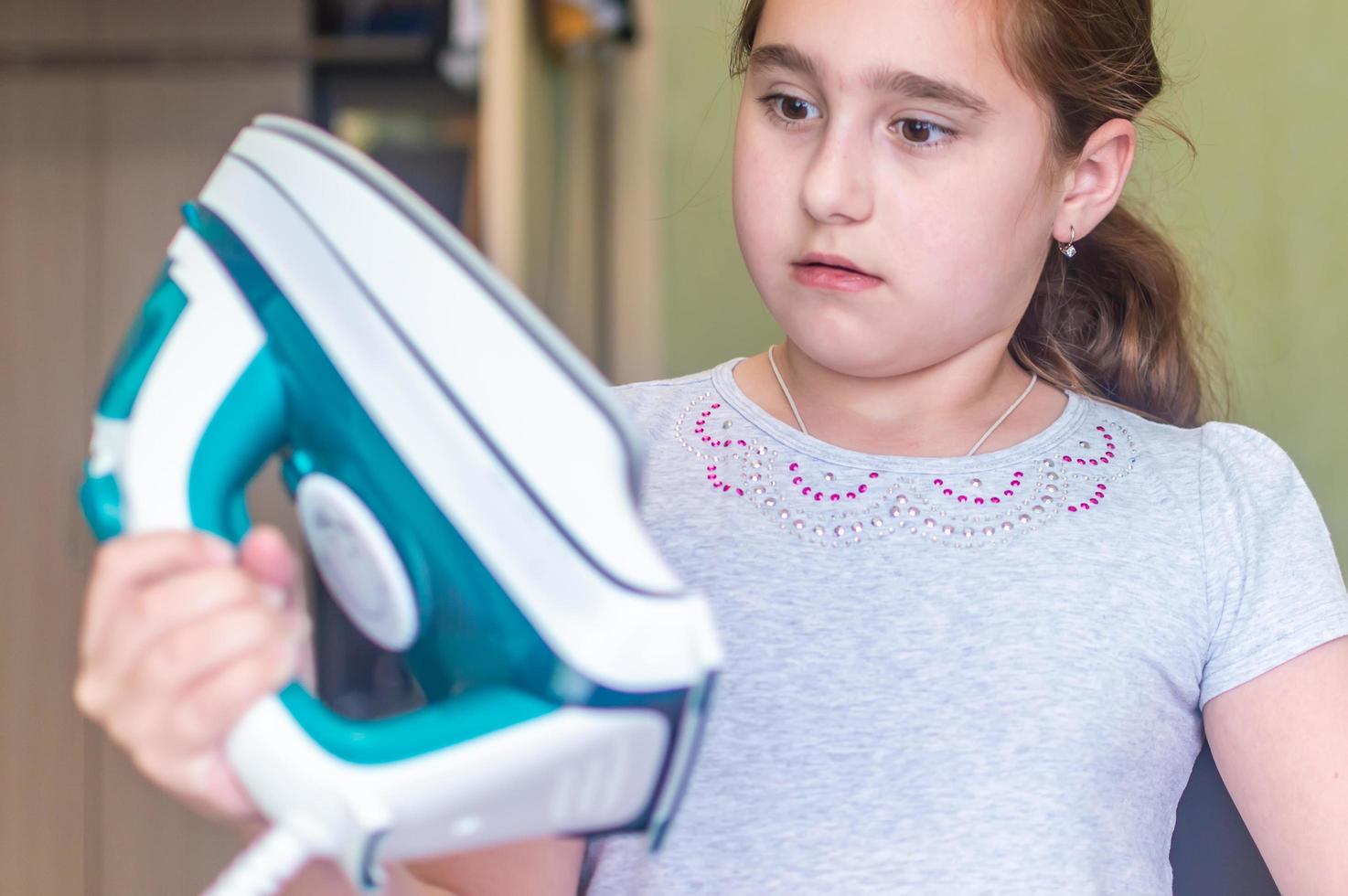 the girl burned clothes with an iron on the Ironing Board photo